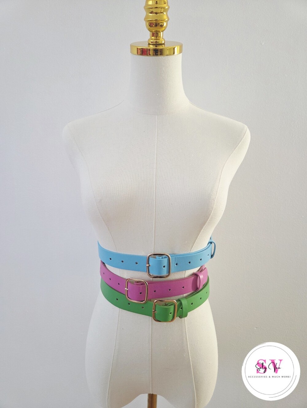 Set of 3 belts in blue, pink, and green.